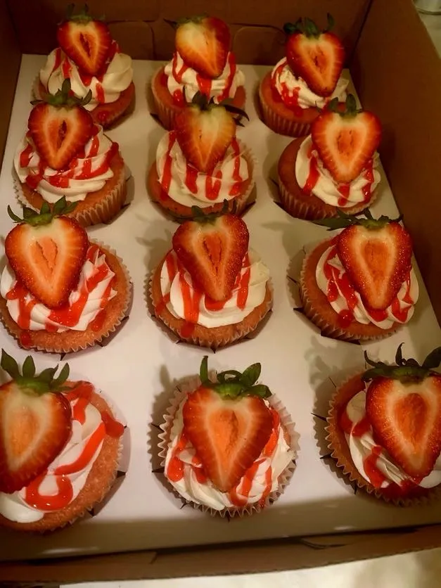 Strawberry cupcakes topped with fresh strawberries